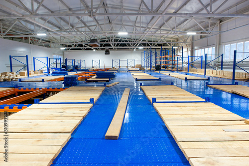 Slika na platnu Assembly of shelving mezzanine in industrial premises