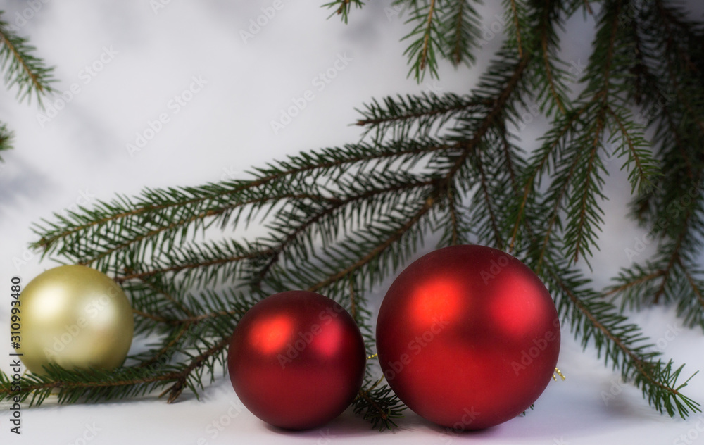 Christmas balls hanging on fir branches on white background Christmas balls hanging on fir branches on white background