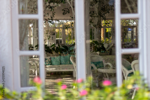 White furniture in the orangery among the decorations. photo