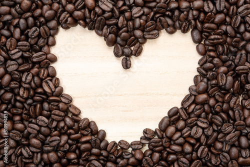 Heart-shaped frame of coffee beans. No edit.