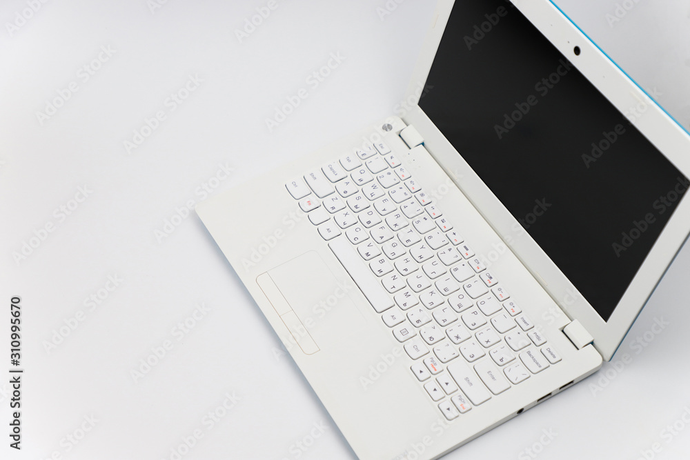 The laptop is white on a white background. The laptop is white on a white background.