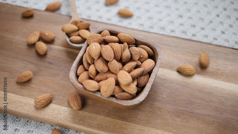 Healthy Food Concept. Almond Nuts In Wooden Bowl. Closeup. Healthy Food Concept. Almond Nuts In Wooden Bowl. Closeup.