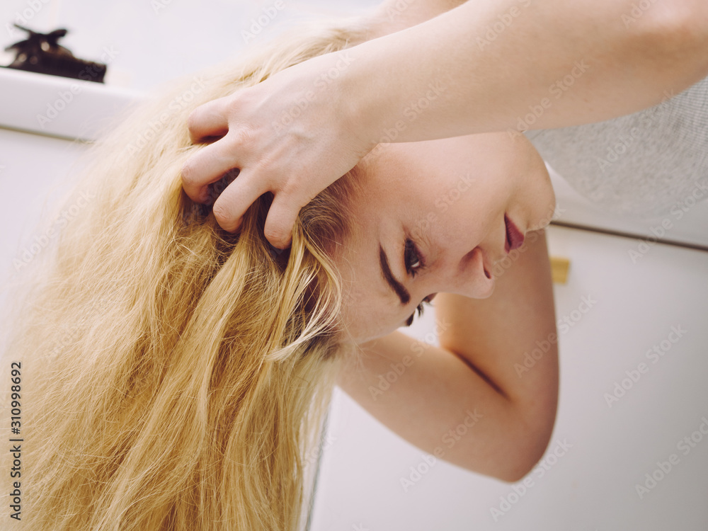Fototapeta premium Female having problem with blonde hair
