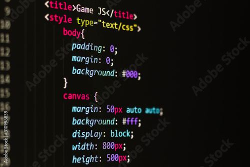 html code on a black background on the monitor