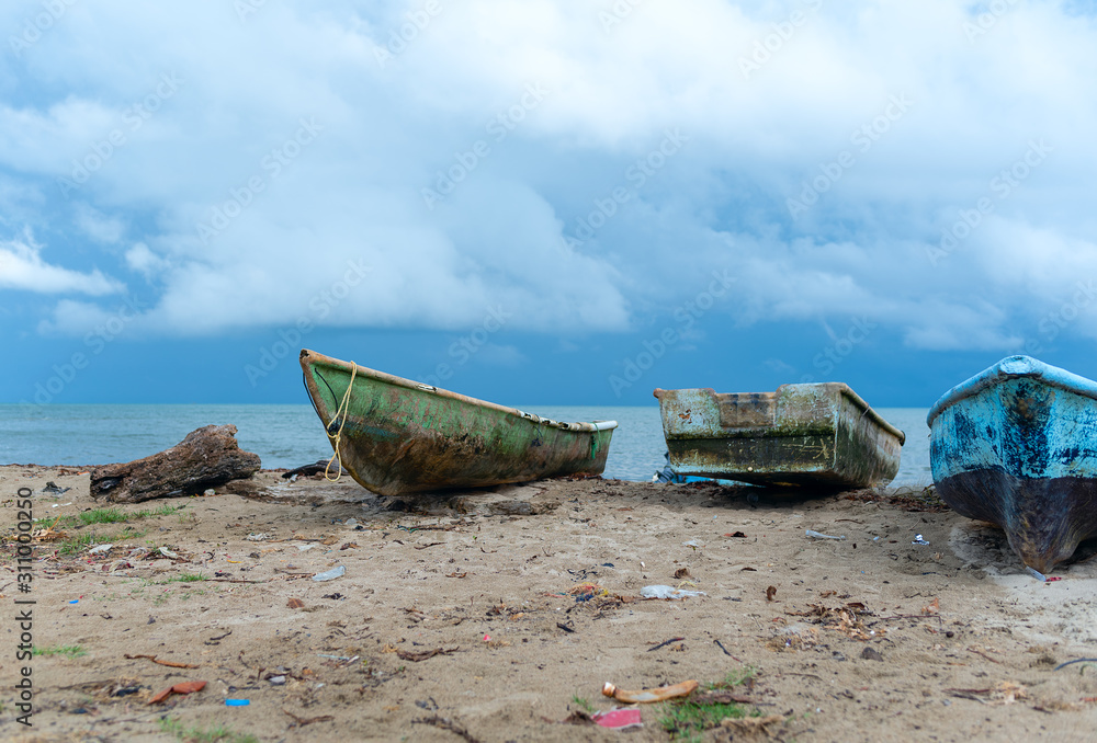 old fishing boats on the ocean before tropical rain old fishing boats on the ocean before tropical rain