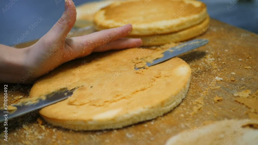 The process of making a cake.Confectioners slices biscuit The process of making a cake.Confectioners slices biscuit