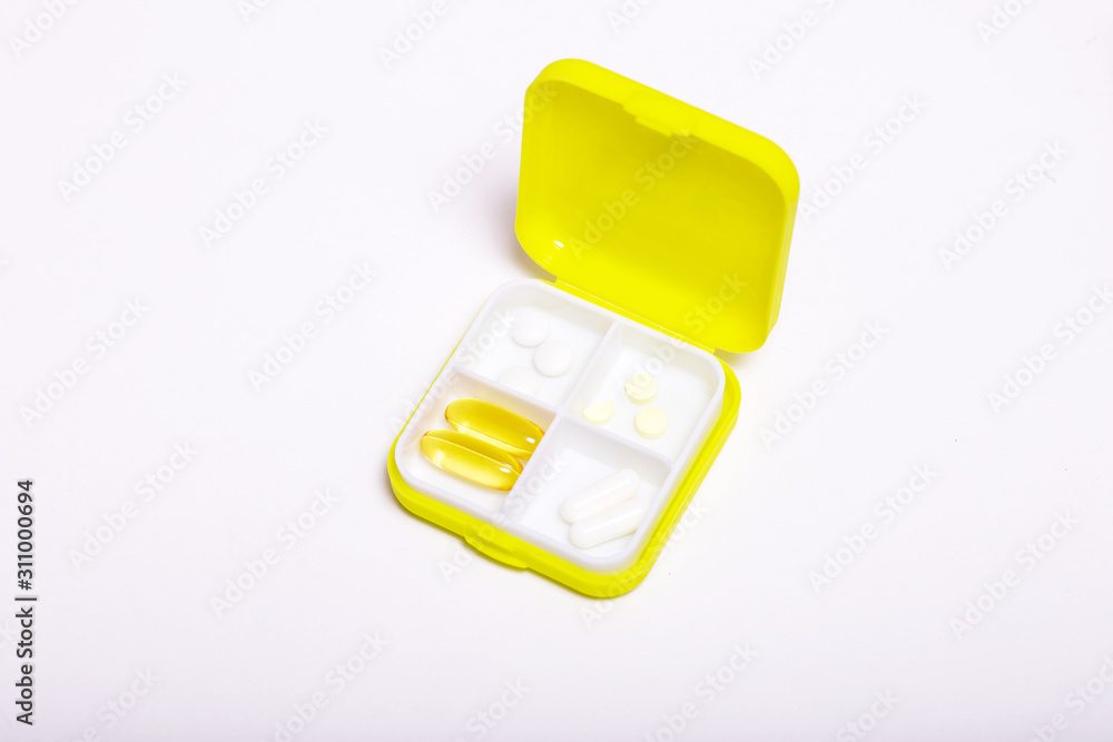 medicine container with pills and capsules on a light background medicine container with pills and capsules on a light background