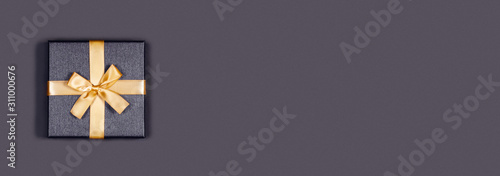 Greeting web banner. Grey background with gift box. Place for the text. Central composition.