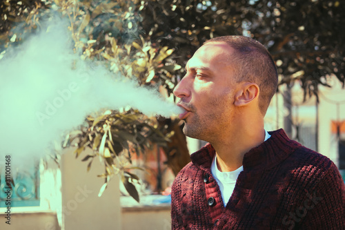 A man smoking an electronic cigarette, vape