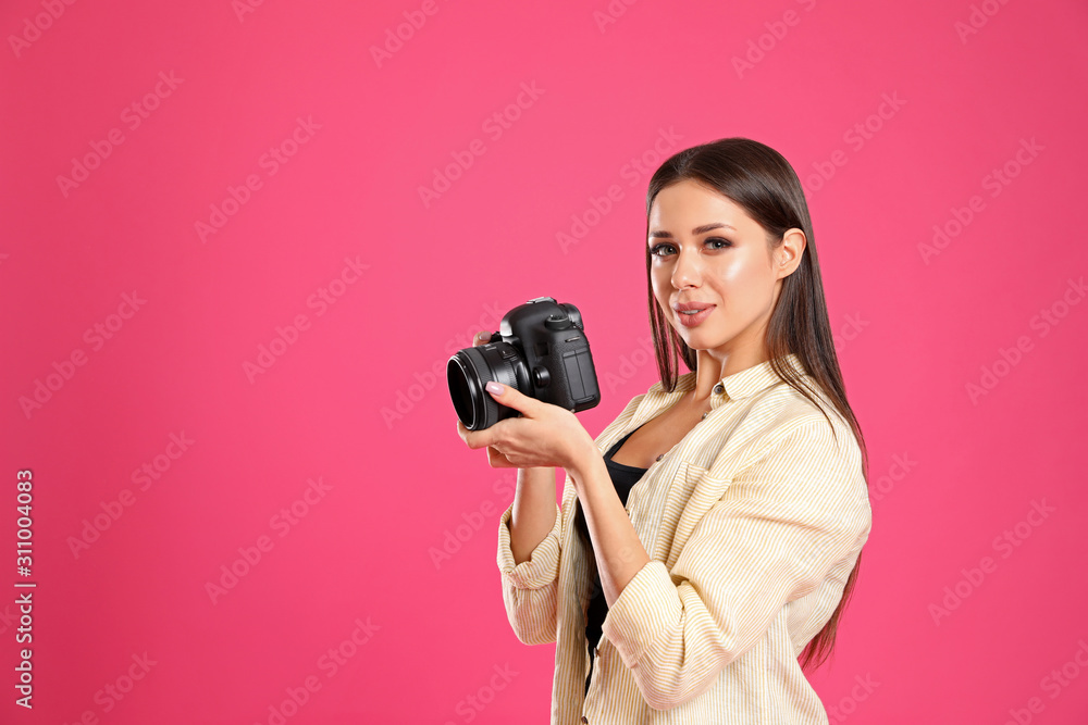 Professional photographer working on pink background in studio. Space for text Professional photographer working on pink background in studio. Space for text