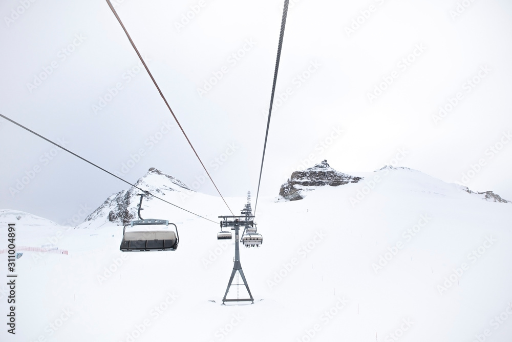 Skiing in Zermatt in winter with ski lifts and view of the Matterhorn