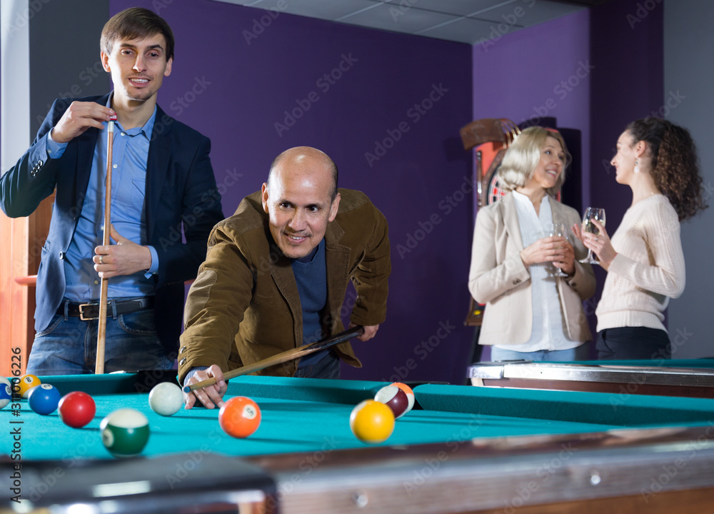 Fototapeta premium young and the old man playing billiards