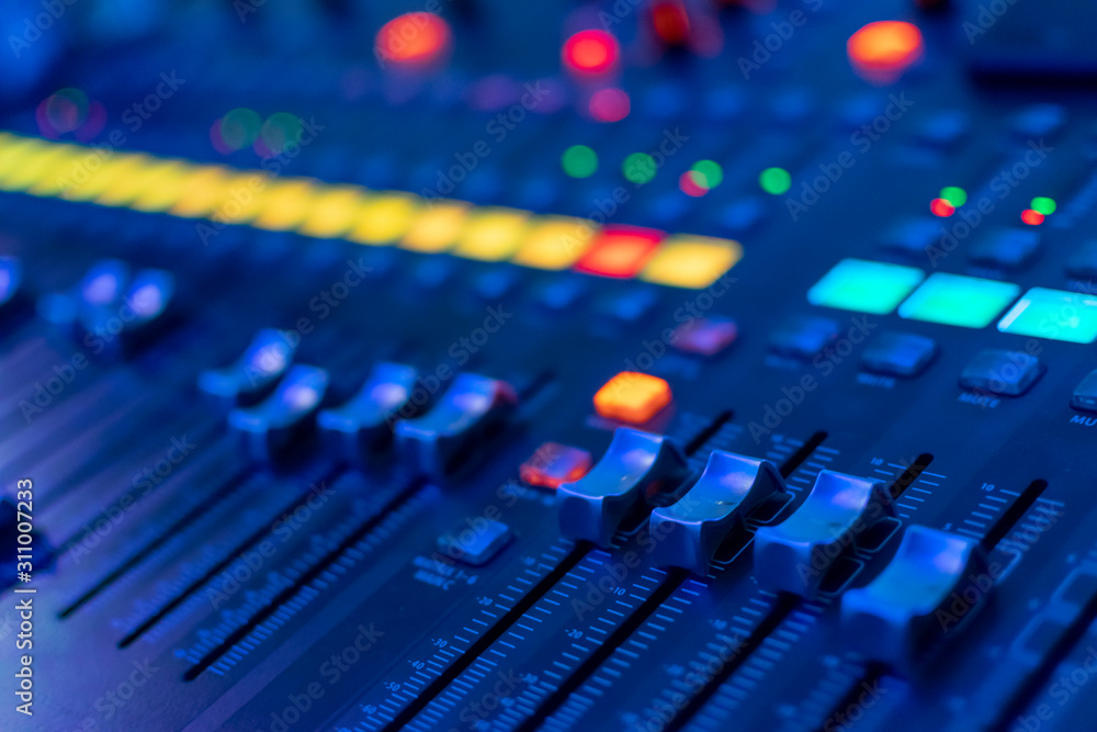 modern electronic mixing console in neon light. selective focus. closeup modern electronic mixing console in neon light. selective focus. closeup