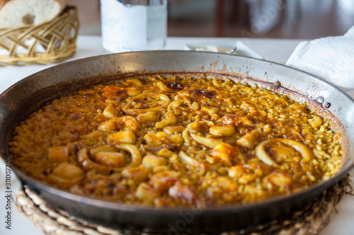 Photograph of the delicious artisanal fish rice (Paella), belonging to the Can Roig restaurant (Alcossebre - Spain) - Before tasting