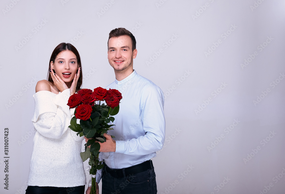 The guy gives the surprised girl flowers. The guy gives the surprised girl flowers.