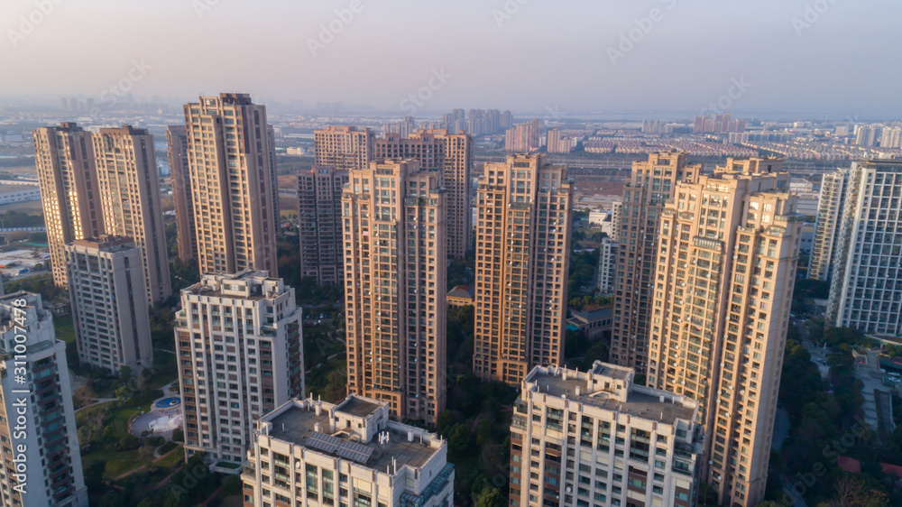 Aerial drone shot over residential apartment buildings on sunset. Aerial shot over community apartment complex in China.