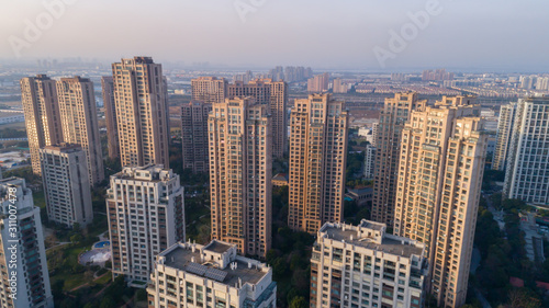Aerial drone shot over residential apartment buildings on sunset. Aerial shot over community apartment complex in China. © Евгений Бахчев