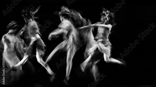  scenography of dancers dancing in black and white, blurred effect photography photo