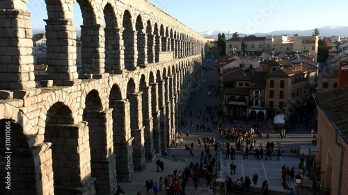 High perspective view of people near the ancient Roman aqueduct in Segovia, Spain on a sunny day