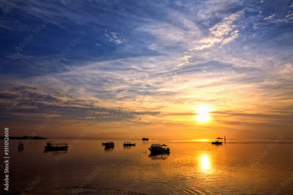 Naklejka premium sunrise over fishing boats on Bali