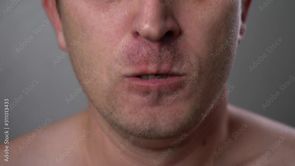 Man with angry facial expression is screaming out loud. Portrait of a shouting man with mouth wide open. Furious yelling man. Anger emotions. Anger. Violence. Mouth and grin close-up. White teeth. Man with angry facial expression is screaming out loud. Portrait of a shouting man with mouth wide open. Furious yelling man. Anger emotions. Anger. Violence. Mouth and grin close-up. White teeth.