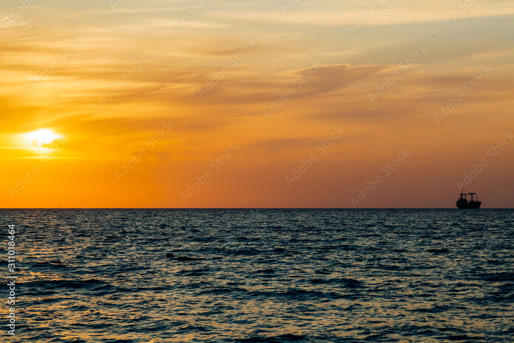Sunset landscape ocean sea and ship on the horizon Sunset landscape ocean sea and ship on the horizon