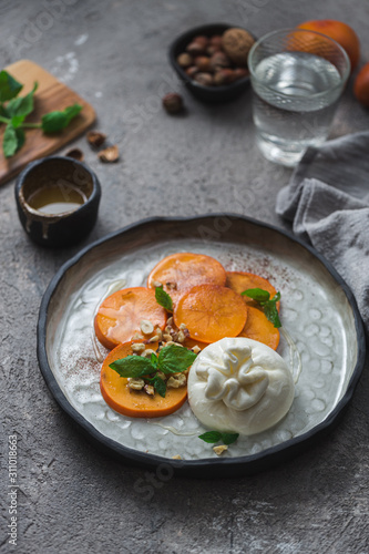 Persimmon and buratta cheese with nuts and honey