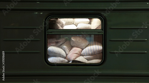 Pillows behind a window if long distance train