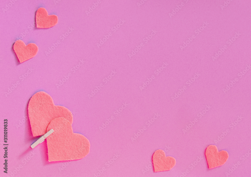 Pink felt hearts on a pink background. St. Valentine's Day and romance concept. Top view, flat lay. Copy space. Pink felt hearts on a pink background. St. Valentine's Day and romance concept. Top view, flat lay. Copy space.