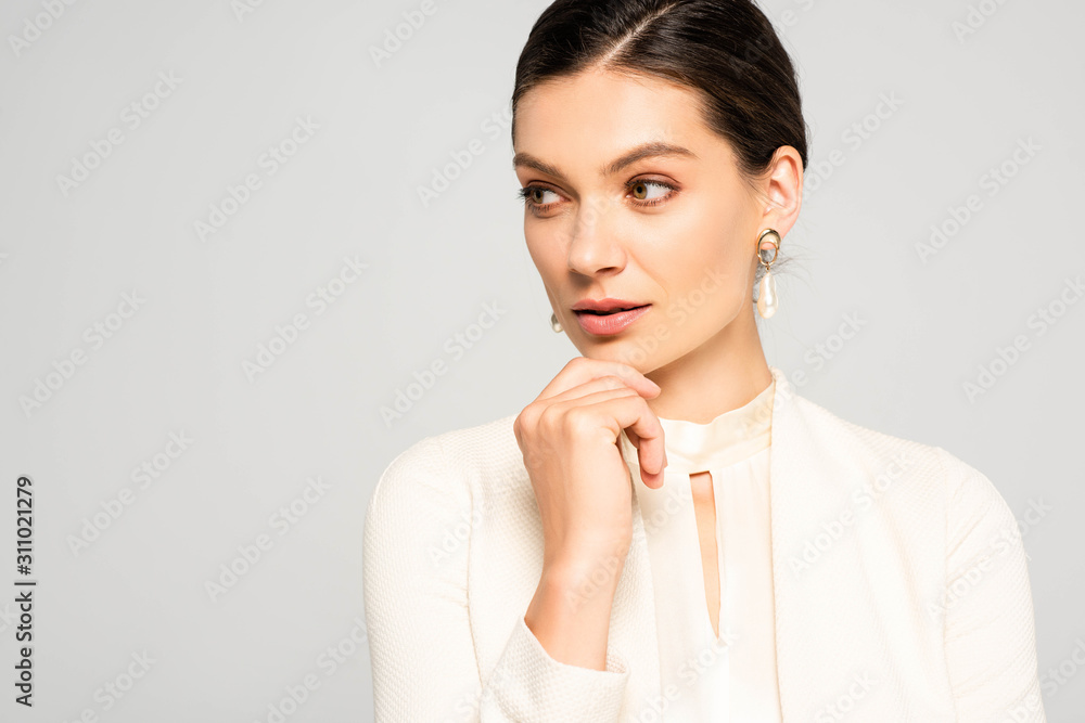thoughtful elegant businesswoman in white suit, isolated on grey thoughtful elegant businesswoman in white suit, isolated on grey