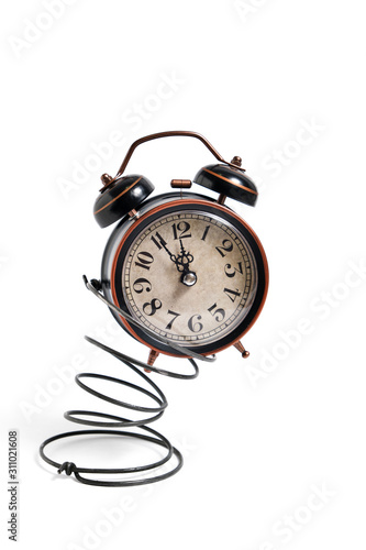 Vintage retro alarm clock Bouncing on a spring on a white background.