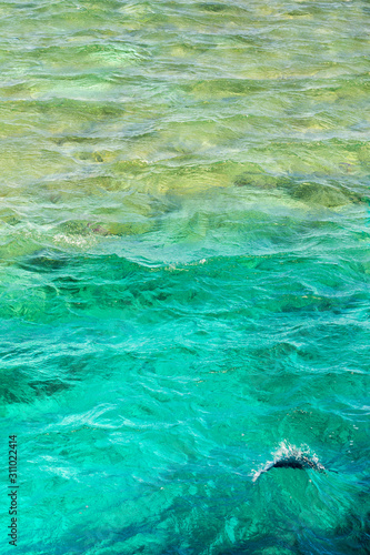 sea waves. Blue water for background. Emerald-colored sea water. vertical photo
