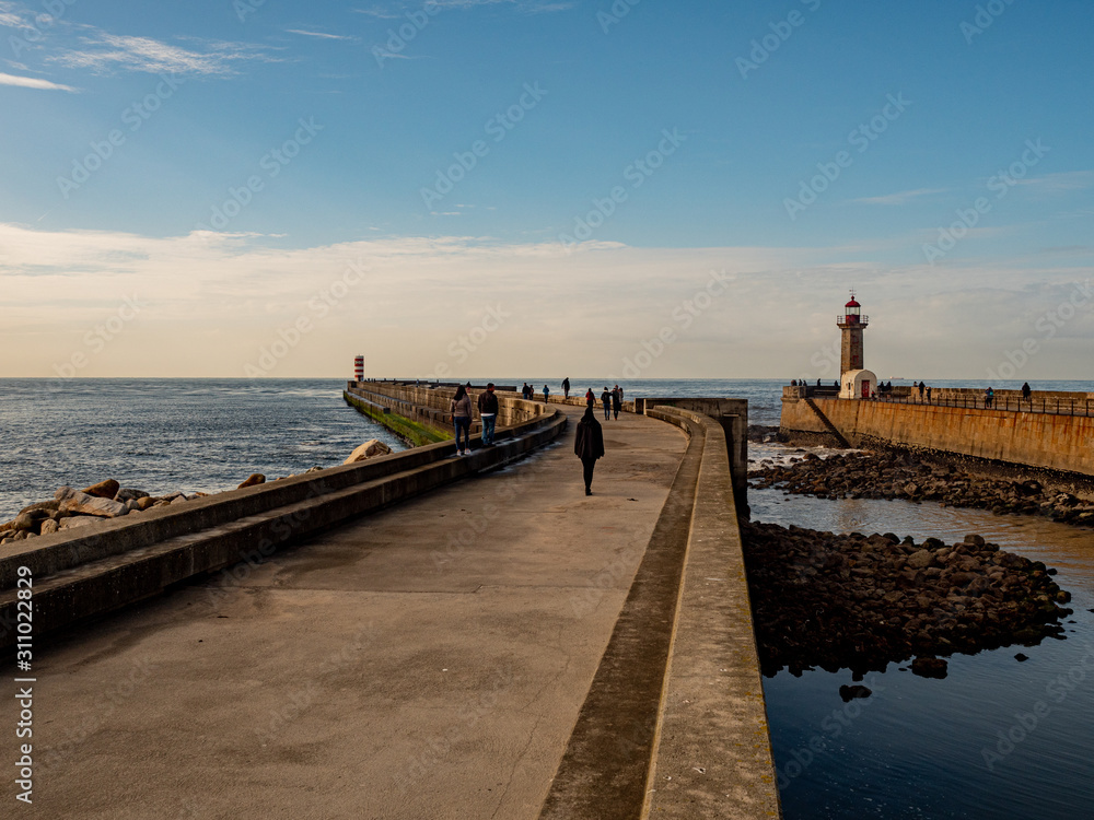 Porto, Portugal. 16 November 2019. Felgueiras Lighthouse standing on a quay at the stormy Atlantic coast off Porto on a sunny autumn day.