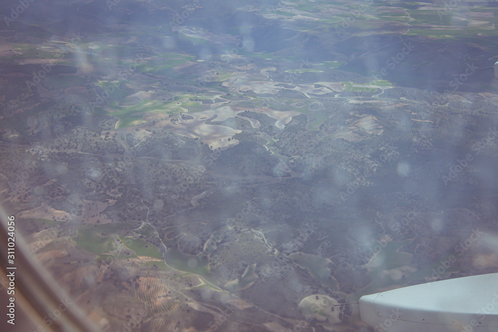 Views of the earth between clouds from an airplane