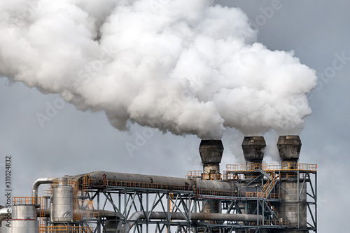 Chemical factory with smoke stack. Smoke emission from factory pipes. Ecology and environmental protection problems, air pollution