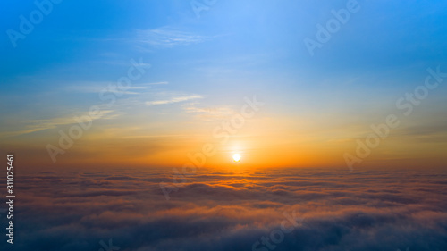 Yellow and blue dawn over clouds  concept  travel and leisure.