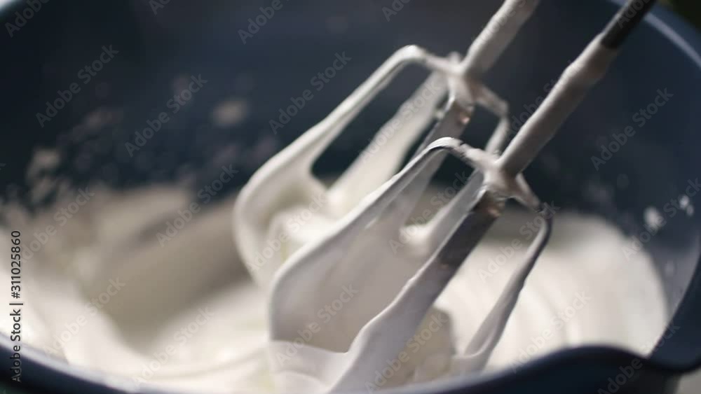 Cooking meringue. Beating egg whites with an electric mixer. Soft focus. Cooking meringue. Beating egg whites with an electric mixer. Soft focus.