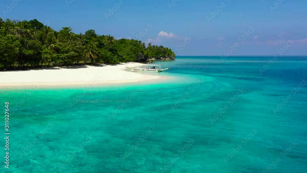 Tropical island with a white beach. Island with palm trees and white sand, top view. Summer and travel vacation concept. Mahaba Island, Philippines. Tropical island with a white beach. Island with palm trees and white sand, top view. Summer and travel vacation concept. Mahaba Island, Philippines.