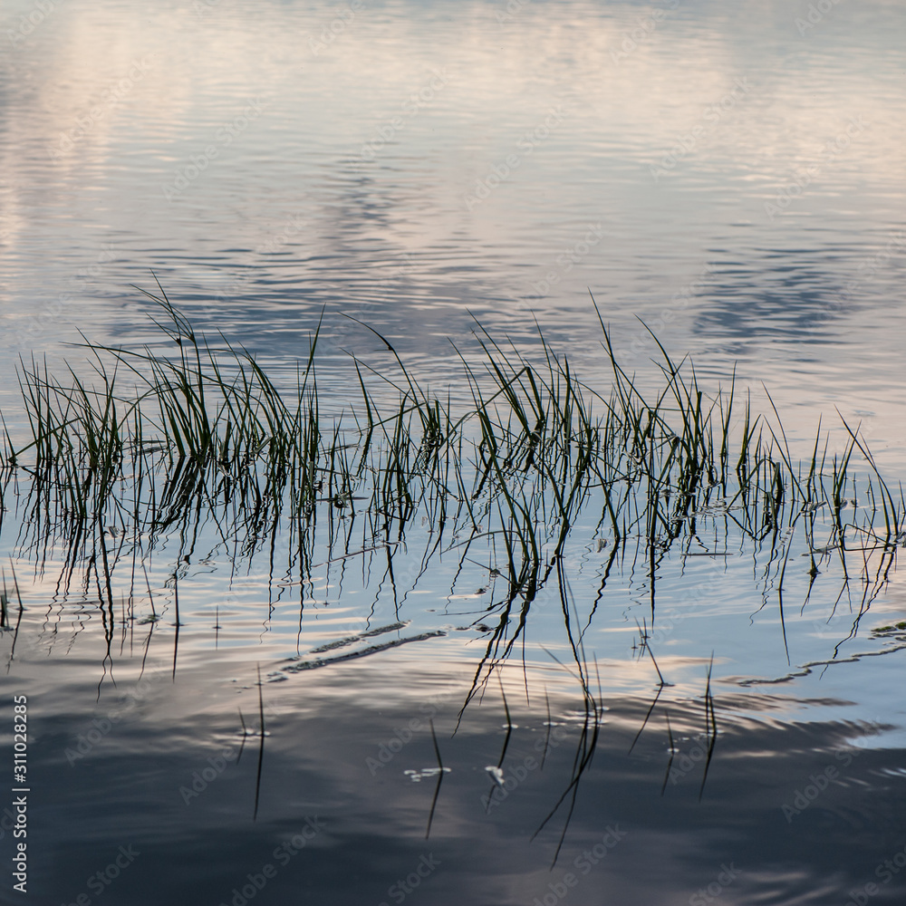 Reflection of the sky in the waves on the surface of the water in the river. Reflection of the sky in the waves on the surface of the water in the river.