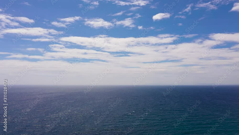 Tropical blue sea and blue sky with clouds. Seascape, aerial view. Flight over the sea. Summer and travel vacation concept. Tropical blue sea and blue sky with clouds. Seascape, aerial view. Flight over the sea. Summer and travel vacation concept.