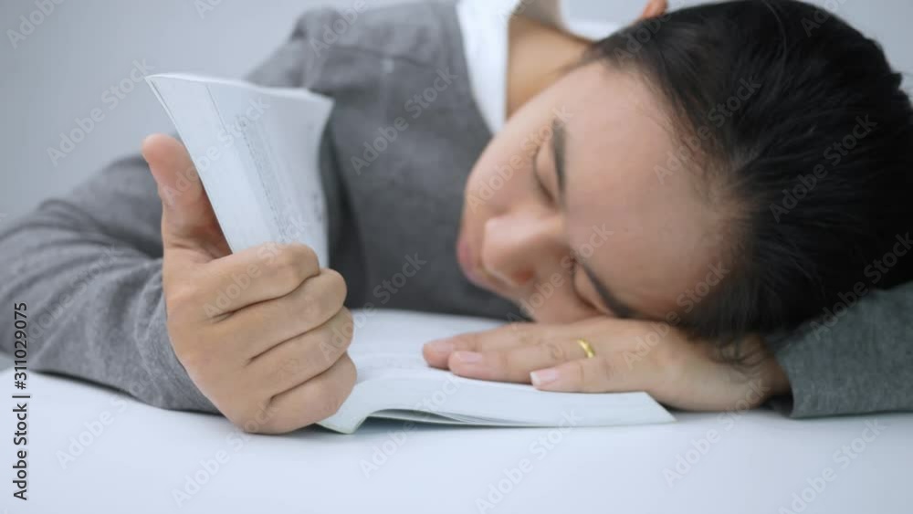 Tired student girl sleeping on the books in room at the Home. Tired student girl sleeping on the books in room at the Home.