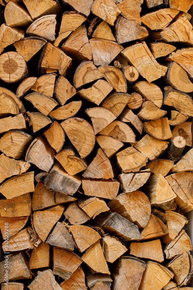 Stack or pile of chopped firewood logs, wood for winter Stack or pile of chopped firewood logs, wood for winter