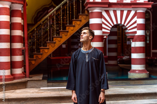 Young tourist in traditional dress visiting Red Mosque Jami-Ul-Alfar in Colombo, Sri Lanka photo