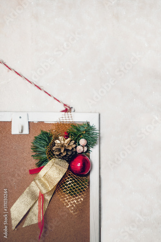 Christmas decor decoration from fir branches, balls and ribbons hanging on a home mudboard on a white background. photo