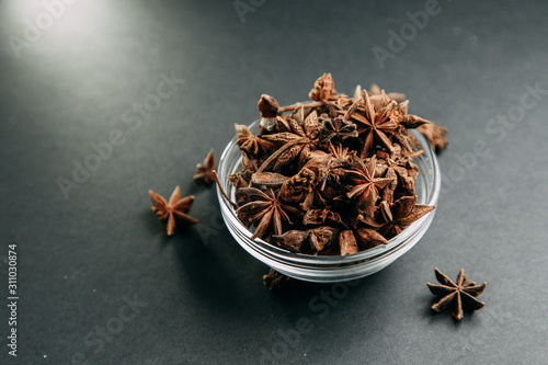 Spices on black background. Star anise in Minsk heap.