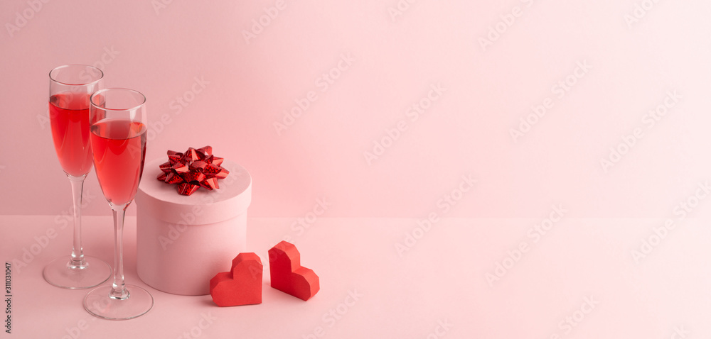 Round gift box, red hearts and glasses of sparkling wine