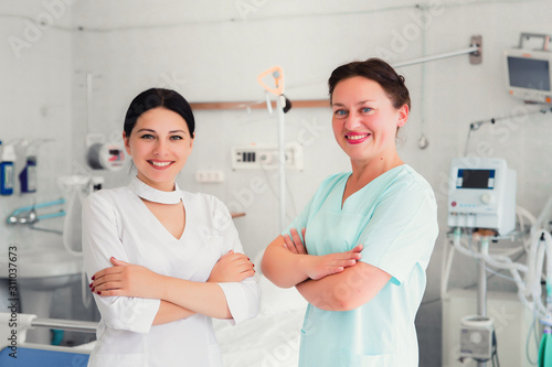 Medical stuff in intensive care and reanimation unit in hospital. Female doctor and nurse in scrubs.