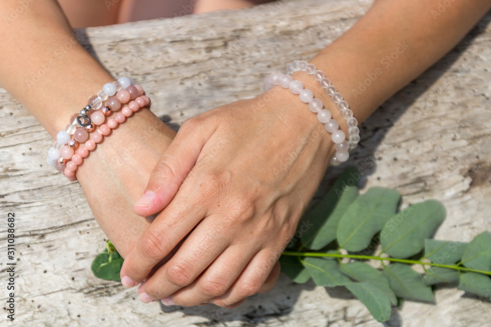 Fashion accessories. Jewelry on female hand. Gemstone bracelets. Natural stones beads.
