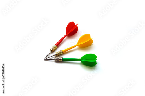 red, green and yellow colored dart arrow, on white ground,