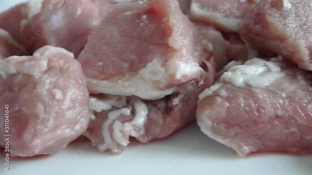 Dolly of raw meat on a white background. Close-up Dolly of raw meat on a white background. Close-up